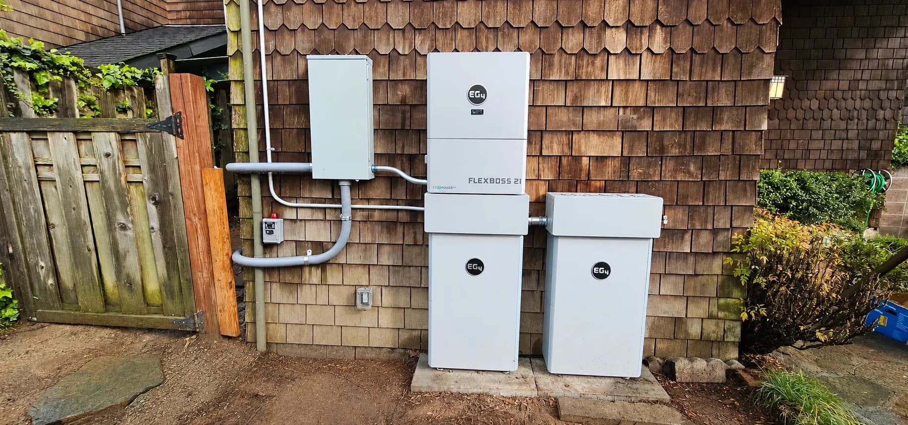 Permitted EG4 FlexBoss 21 and two PowerPro batteries on a brown-shingle Berkeley home